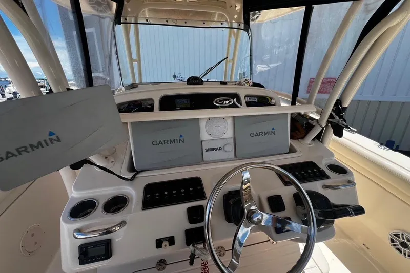 Slide: The Image of 2015 Grady-White Canyon 336 boat dashboard with Garmin navigation displays. - 18