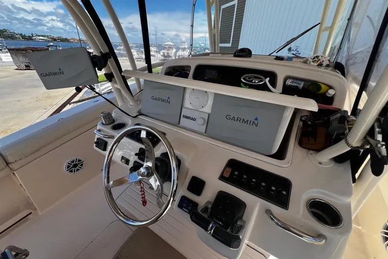 Slide: The Image of 2015 Grady-White Canyon 336 boat dashboard with Garmin navigation systems. - 21