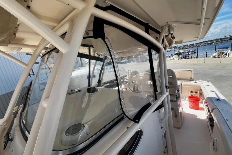 Slide: The Image of 2015 Grady-White Canyon 336 boat interior with clear enclosure, dockside view. - 22