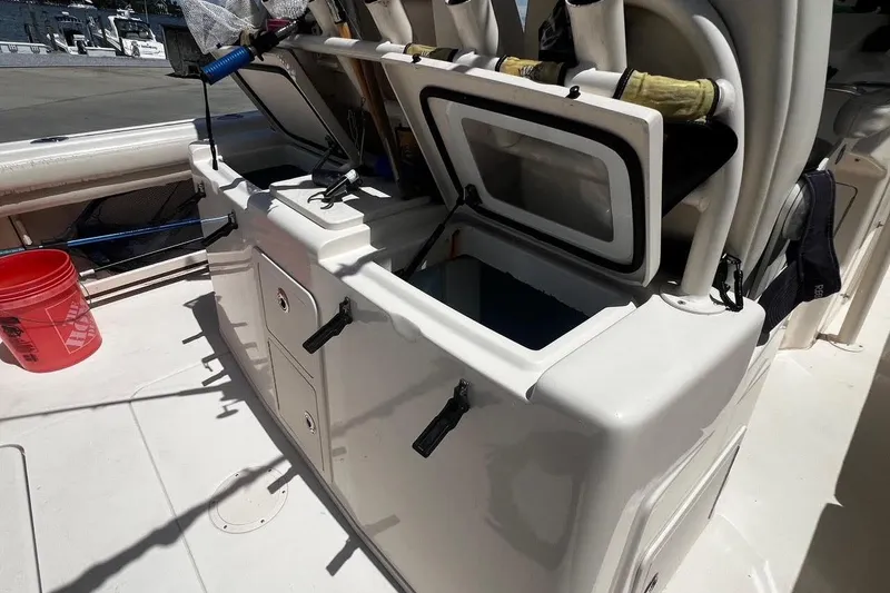 Slide: The Image of 2015 Grady-White Canyon 336 boat deck with open storage compartments. - 28