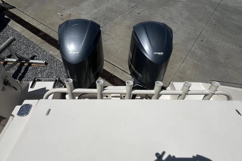 Slide: The Image of 2015 Grady-White Canyon 336 boat with dual outboard engines, docked on concrete. - 31