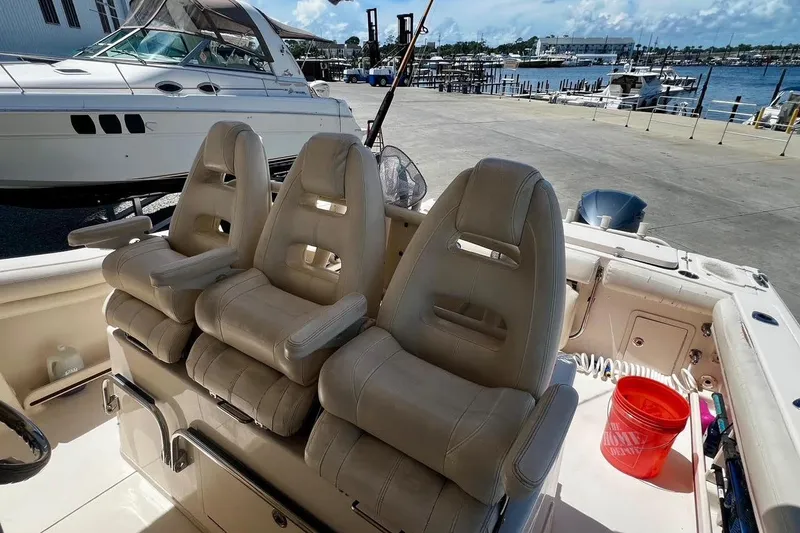 Slide: The Image of 2015 Grady-White Canyon 336 boat interior with three cushioned seats at the dock. - 33