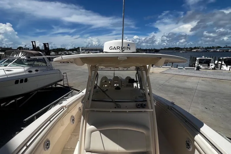 Slide: The Image of 2015 Grady-White Canyon 336 boat docked with Garmin equipment, under a clear blue sky. - 37