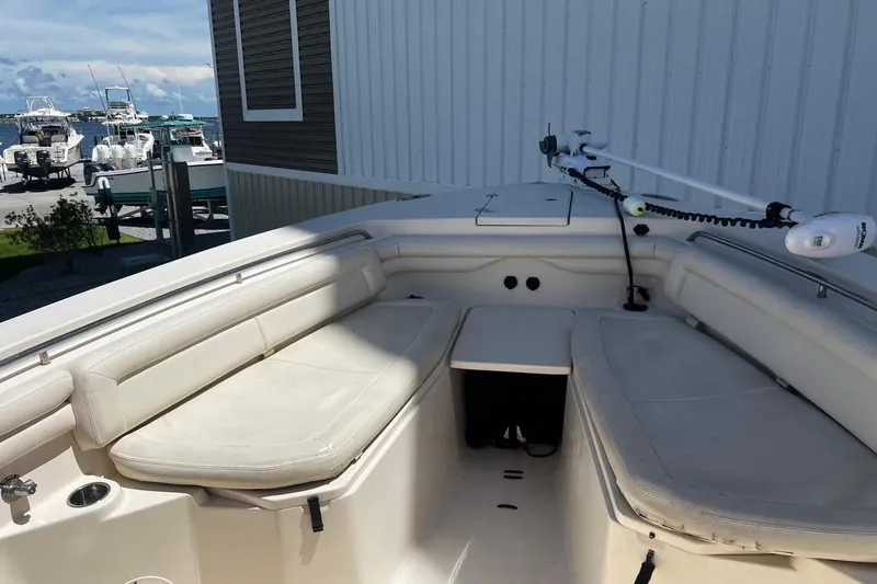 Slide: The Image of 2015 Grady-White Canyon 336 boat interior with cushioned seating and fishing equipment. - 38