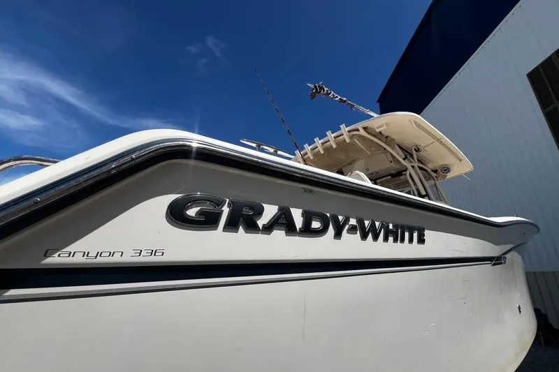Slide: The Image of 2015 Grady-White Canyon 336 boat with sleek design under clear blue sky. - 39