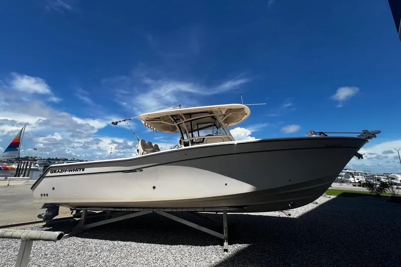 Slide: The Image of 2015 Grady-White Canyon 336 boat displayed outdoors under a clear blue sky. - 41