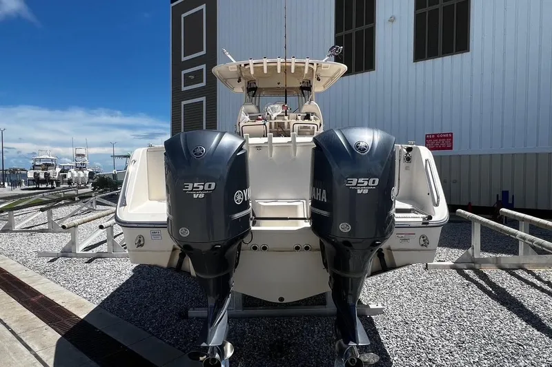 Slide: The Image of 2015 Grady-White Canyon 336 boat with twin Yamaha 350 V8 engines, docked outdoors. - 43