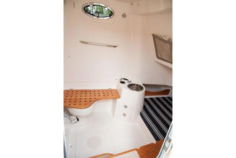 Slide: The Image of Manufacturer Provided Image: 2015 Grady-White Canyon 336 boat interior with toilet and wooden bench. - 46