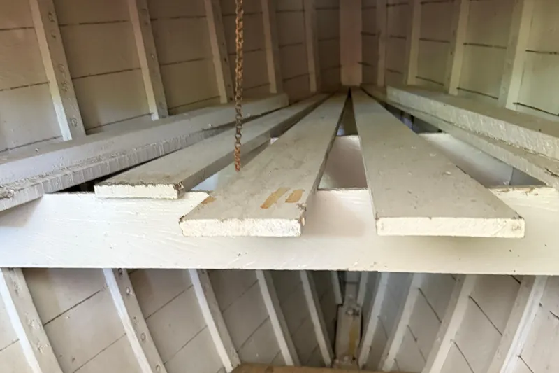 Slide: The Image of Interior view of 1904 Fay & Bowen Torpedo Launch, showcasing wooden slats and structure. - 15