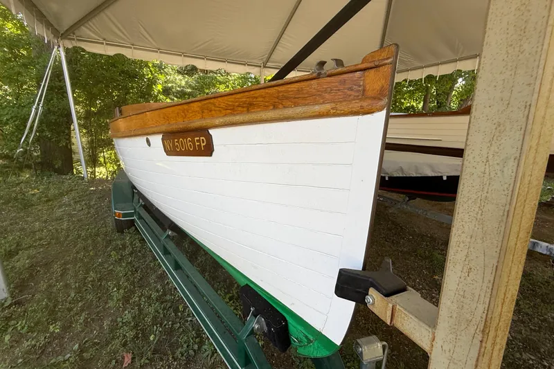 Slide: The Image of 1904 Fay & Bowen Torpedo Launch boat on trailer under canopy. - 3
