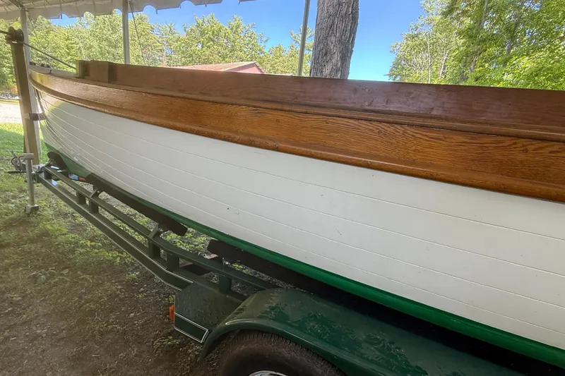 Slide: The Image of 1904 Fay & Bowen Torpedo Launch on trailer, showcasing wooden and white hull under a canopy. - 5