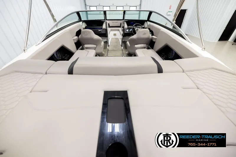 Slide: The Image of 2024 Four Winns H4 boat interior with beige seating and modern dashboard. - 13