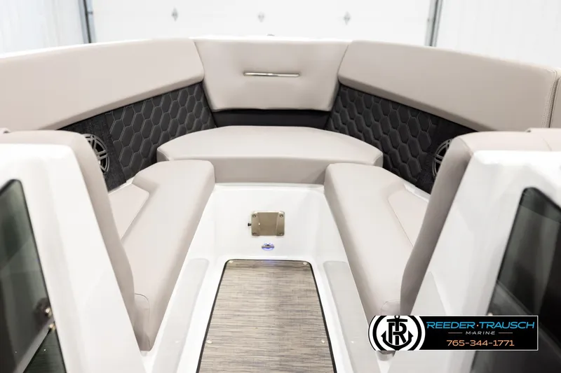 Slide: The Image of 2024 Four Winns H4 boat interior with beige seating and hexagonal pattern accents. - 15