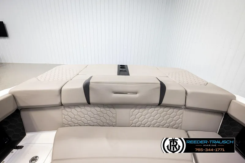 Slide: The Image of 2024 Four Winns H4 boat interior with beige seating and hexagonal pattern design. - 23