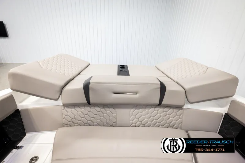 Slide: The Image of 2024 Four Winns H4 boat interior with beige cushioned seating and hexagonal stitching. - 26