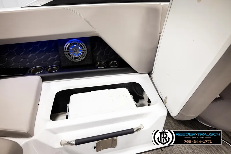 Slide: The Image of 2024 Four Winns H4 boat interior with storage compartment and speaker system. - 30