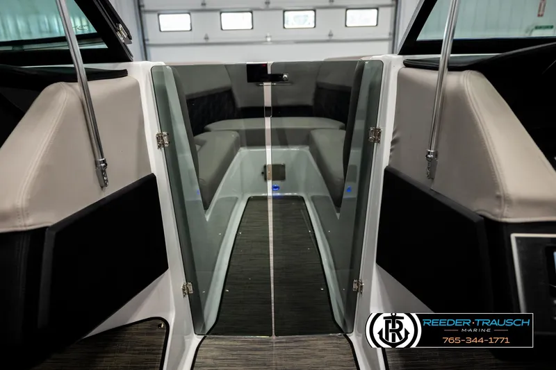 Slide: The Image of 2024 Four Winns H4 boat interior with sleek seating and glass door. - 31