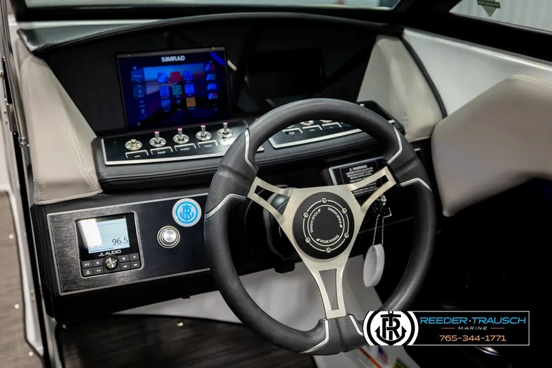 Slide: The Image of 2024 Four Winns H4 boat dashboard with steering wheel and digital controls. - 34