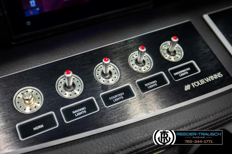 Slide: The Image of Control panel of 2024 Four Winns H4 boat with labeled switches for various lights. - 37