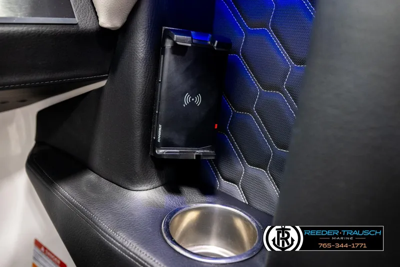 Slide: The Image of 2024 Four Winns H4 interior with wireless charger and cup holder, featuring hexagonal pattern upholstery. - 41