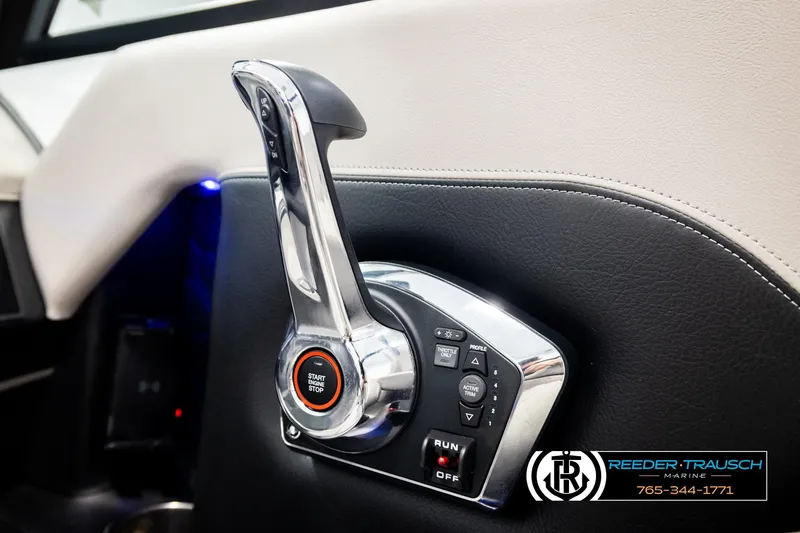 Slide: The Image of 2024 Four Winns H4 boat throttle control with start/stop button and Reeder-Trausch Marine logo. - 42
