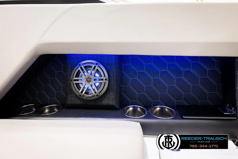 Slide: The Image of 2024 Four Winns H4 boat interior with speaker, cup holders, and blue LED lighting. - 49