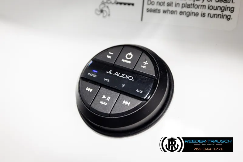 Slide: The Image of 2024 Four Winns H4 JL Audio control panel with volume and source buttons. - 52