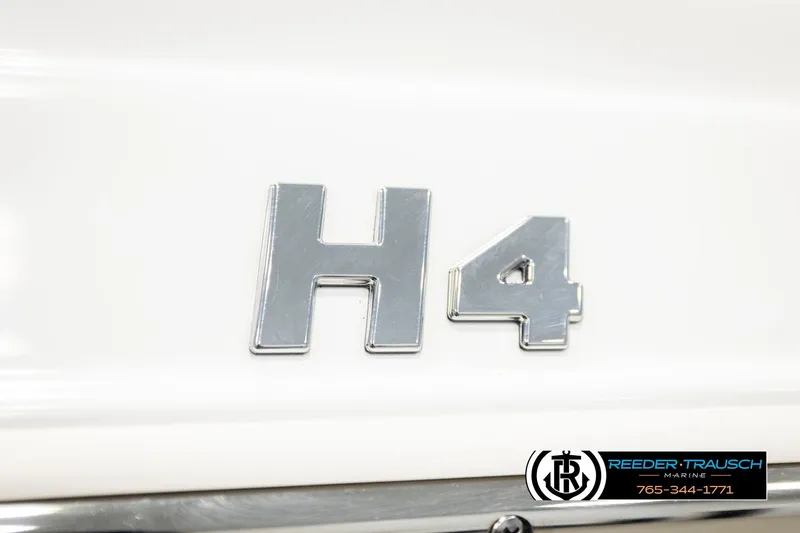 Slide: The Image of 2024 Four Winns H4 emblem on white surface, featuring Reeder-Trausch Marine logo. - 63