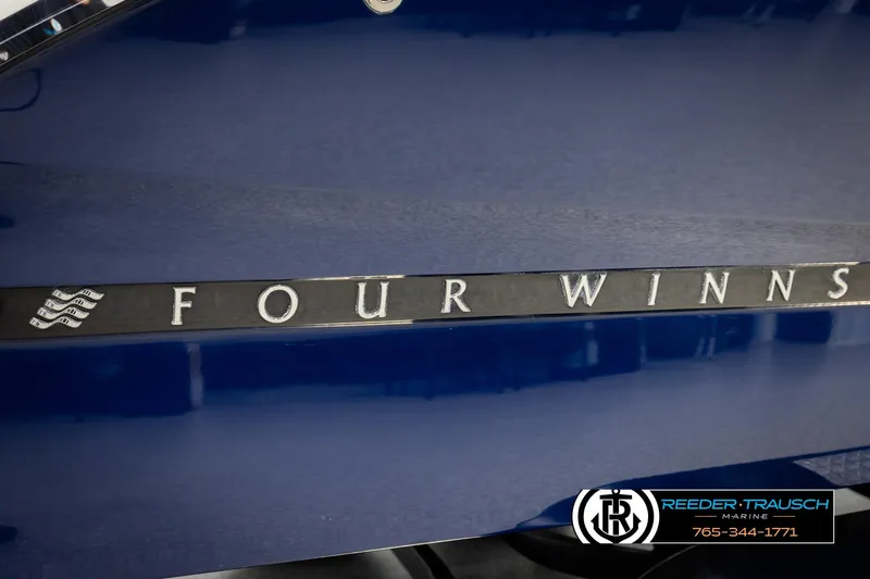Slide: The Image of 2024 Four Winns H4 boat logo on a sleek blue surface. - 64