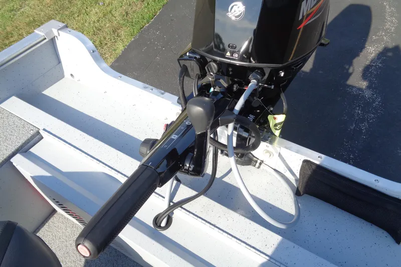 Slide: The Image of 2026 Lund 1400 Fury Tiller boat with Mercury outboard motor, close-up view. - 12