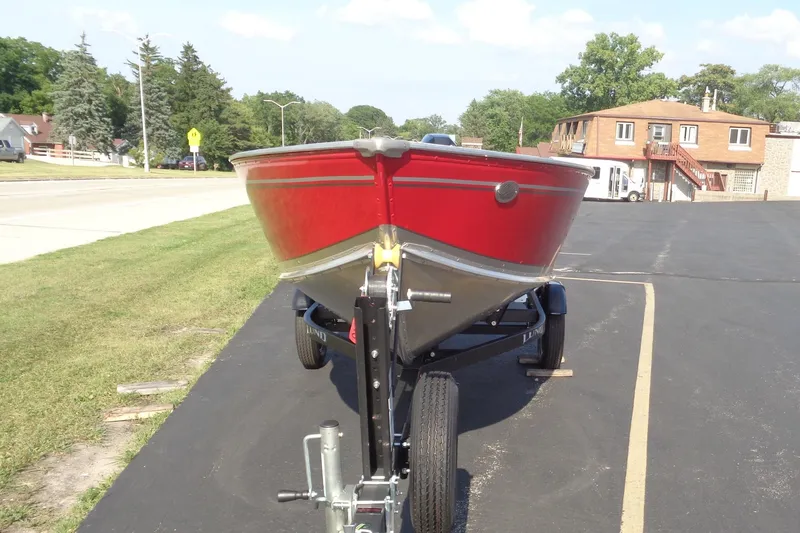 Slide: The Image of 2026 Lund 1400 Fury Tiller boat on trailer, parked on asphalt near grassy area. - 6