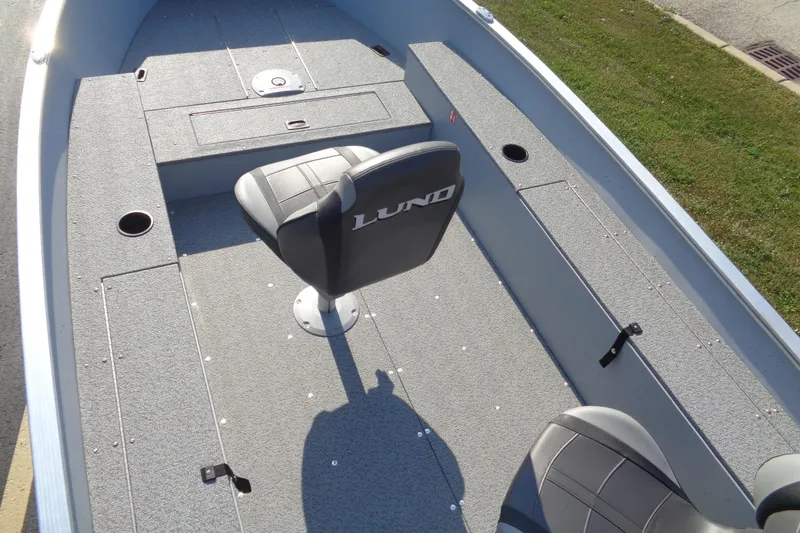 Slide: The Image of 2026 Lund 1400 Fury Tiller boat interior with seating and storage compartments. - 7