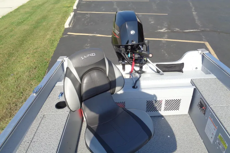 Slide: The Image of 2026 Lund 1400 Fury Tiller boat interior with motor and seating. - 9