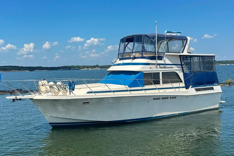Slide: The Image of 1985 Chris-Craft 426 Catalina yacht on calm water under a clear blue sky. - 1