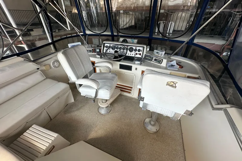 Slide: The Image of 1985 Chris-Craft 426 Catalina helm with dual seats, control panel, and panoramic windows. - 13