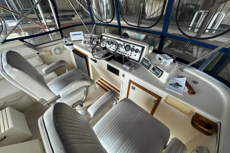 Slide: The Image of 1985 Chris-Craft 426 Catalina helm with dual seats, steering wheel, and navigation instruments. - 15