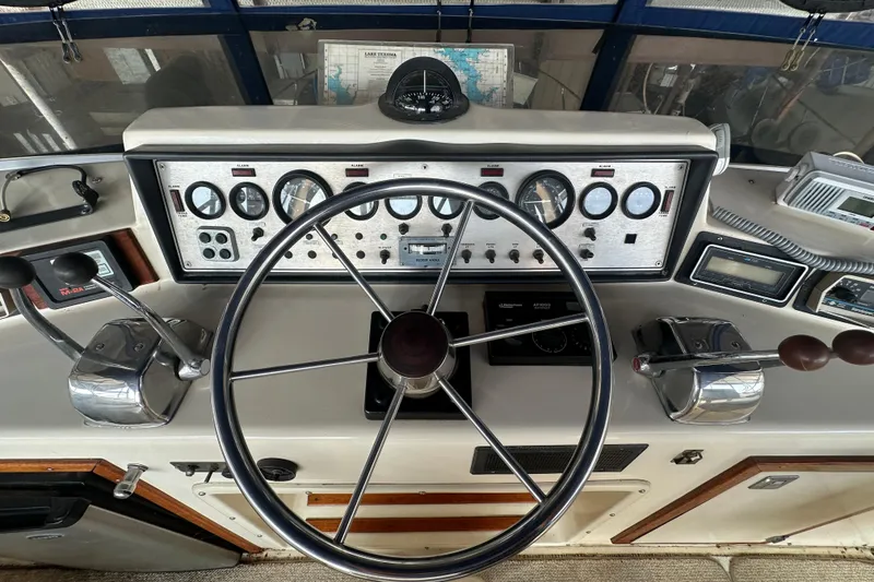 Slide: The Image of 1985 Chris-Craft 426 Catalina helm with steering wheel, gauges, and controls. - 16