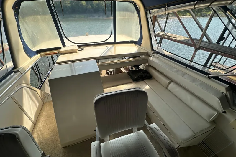Slide: The Image of 1985 Chris-Craft 426 Catalina interior with seating, helm, and water view. - 17