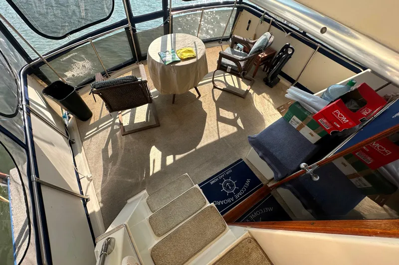 Slide: The Image of 1985 Chris-Craft 426 Catalina yacht interior with table, chairs, and nautical decor. - 18