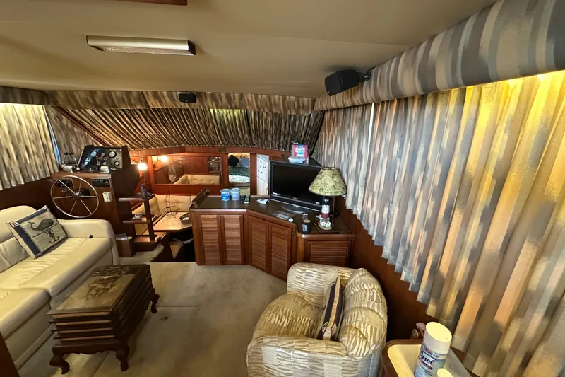 Slide: The Image of Interior of 1985 Chris-Craft 426 Catalina yacht with cozy seating and nautical decor. - 19