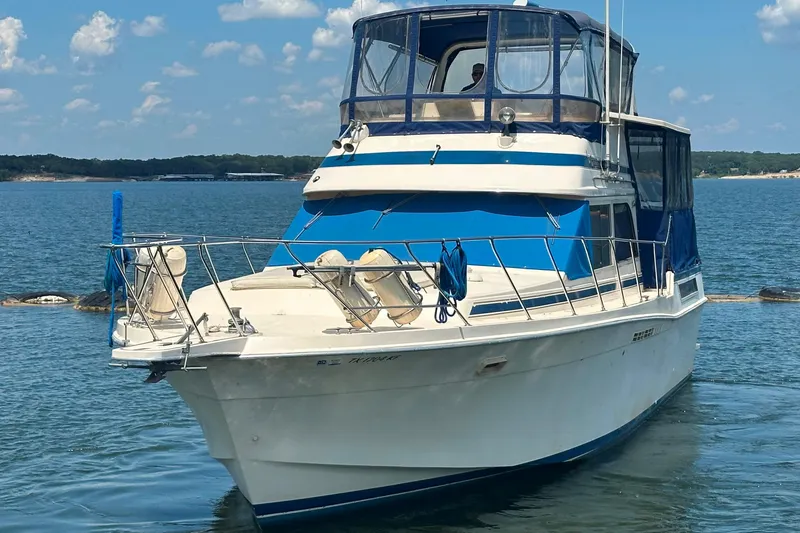 Slide: The Image of 1985 Chris-Craft 426 Catalina yacht on calm water under a clear sky. - 2