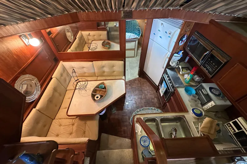 Slide: The Image of Interior of 1985 Chris-Craft 426 Catalina yacht with kitchen and dining area. - 27