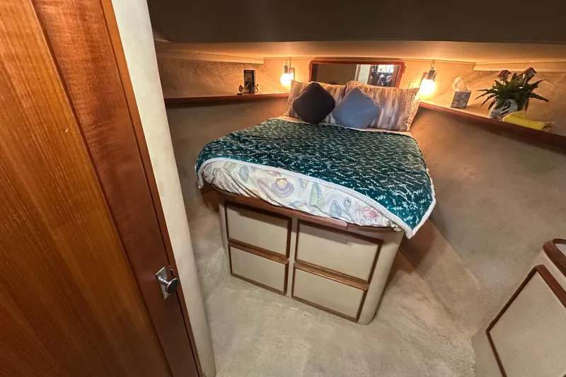 Slide: The Image of Cozy bedroom in 1985 Chris-Craft 426 Catalina yacht with elegant bedding and warm lighting. - 34