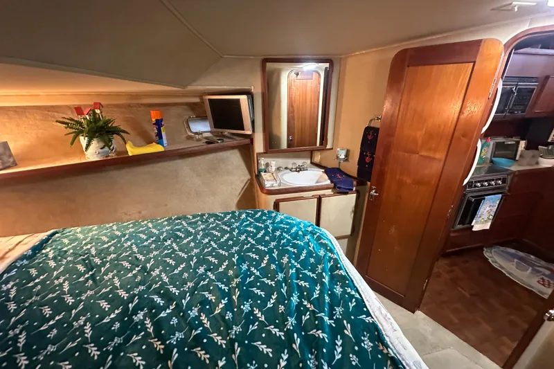 Slide: The Image of Interior of 1985 Chris-Craft 426 Catalina with cozy bedroom and compact kitchenette. - 36