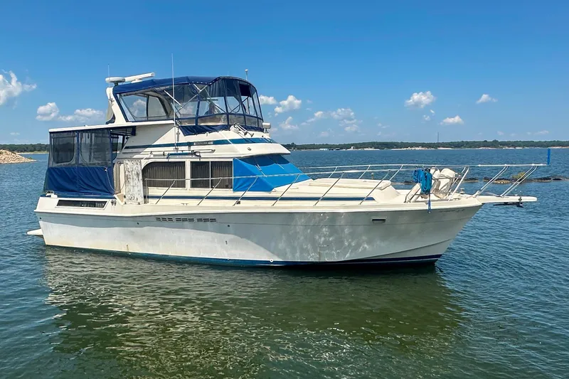 Slide: The Image of 1985 Chris-Craft 426 Catalina yacht on calm water under a clear blue sky. - 4