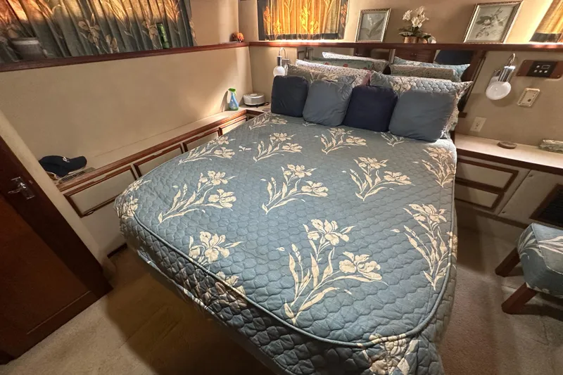 Slide: The Image of Cozy bedroom in 1985 Chris-Craft 426 Catalina yacht with floral bedding and elegant decor. - 42