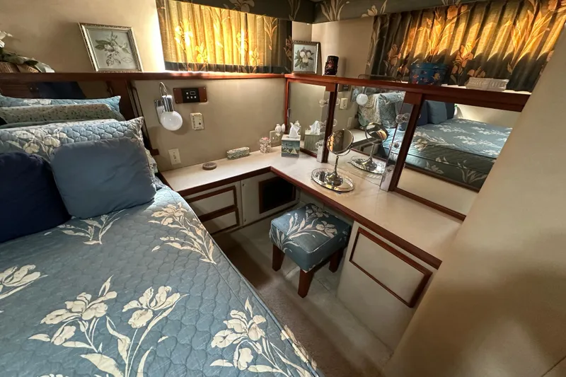 Slide: The Image of Luxurious 1985 Chris-Craft 426 Catalina cabin with floral decor and elegant vanity area. - 43