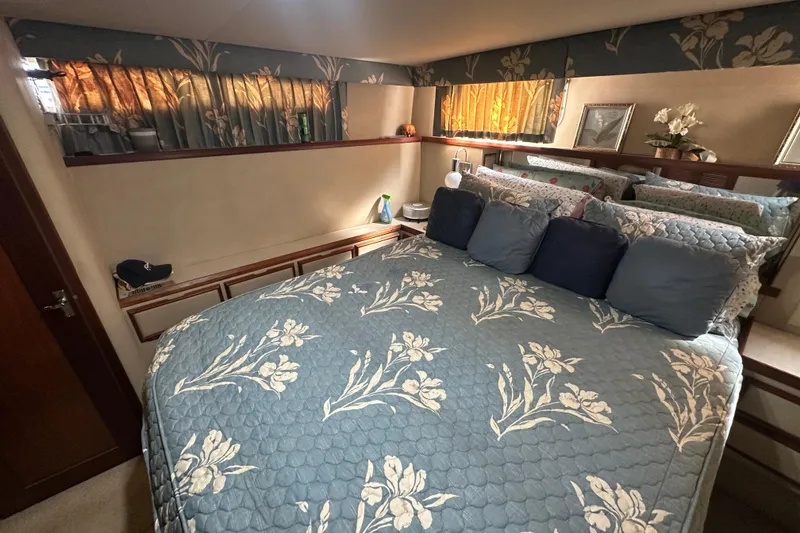 Slide: The Image of Cozy bedroom interior of 1985 Chris-Craft 426 Catalina with floral bedding and decorative pillows. - 45
