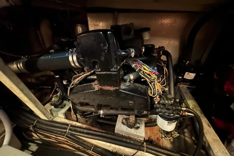 Slide: The Image of Engine compartment of a 1985 Chris-Craft 426 Catalina boat, showcasing mechanical components. - 48