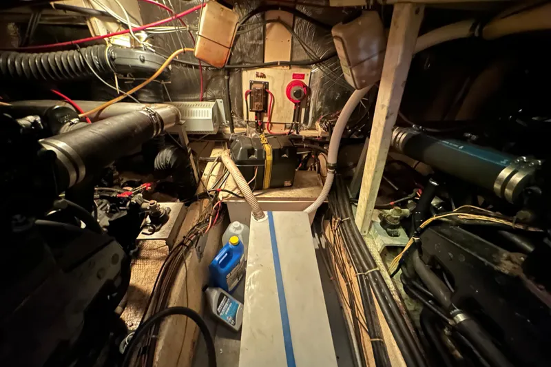Slide: The Image of Engine room of 1985 Chris-Craft 426 Catalina with visible machinery and wiring. - 49